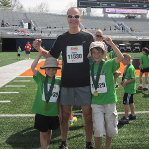 Tom with Theodore and Nathaniel at end of 5K race