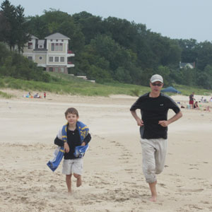 Tom and Nathaniel running on a beach