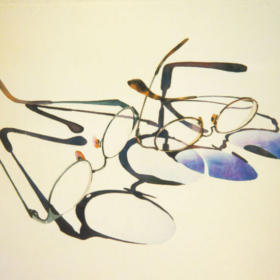 2 pairs eyeglasses casting shadows
