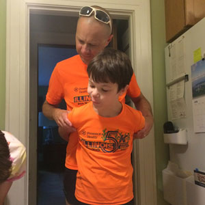 Theodore hugging Tom from behind