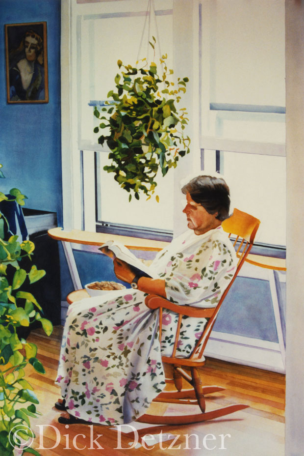 woman in a rocking chair reading a book