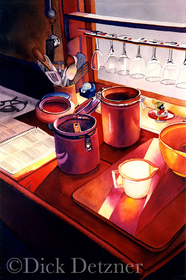 flour and sugar cannisters, a cookbook and a cutting board on a kitchen table