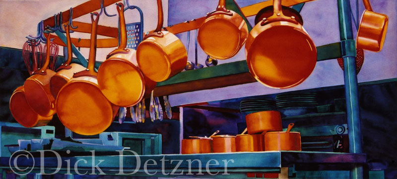 row of pots and pans hanging from a rack