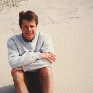 young Tom sitting on rthe beach